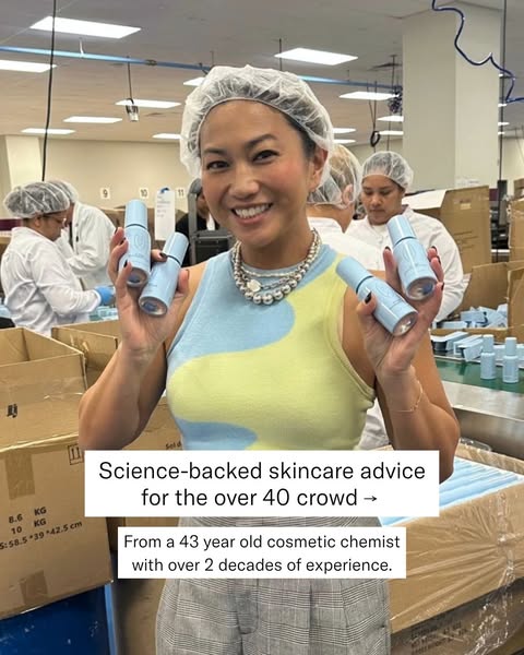 An image ad for a skincare brand featuring a cosmetic chemist holding up the product in what appears to be a manufacturi
