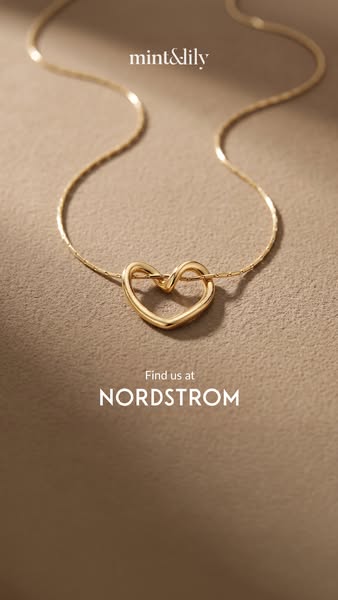 This ad is for Mint & Lily jewelry. It shows a close-up of a delicate gold necklace with a heart pendant. The ad inc
