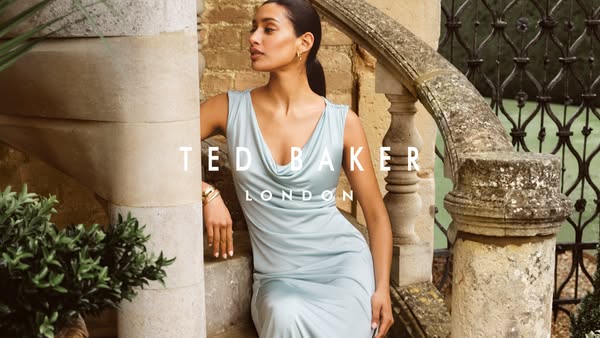 This image ad for Ted Baker London features a woman wearing a light blue dress leaning against a stone railing. The bran