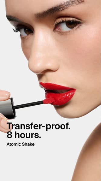 A close-up of a woman's face as she applies red lipstick with a wand, emphasizing the transfer-proof and long-lastin