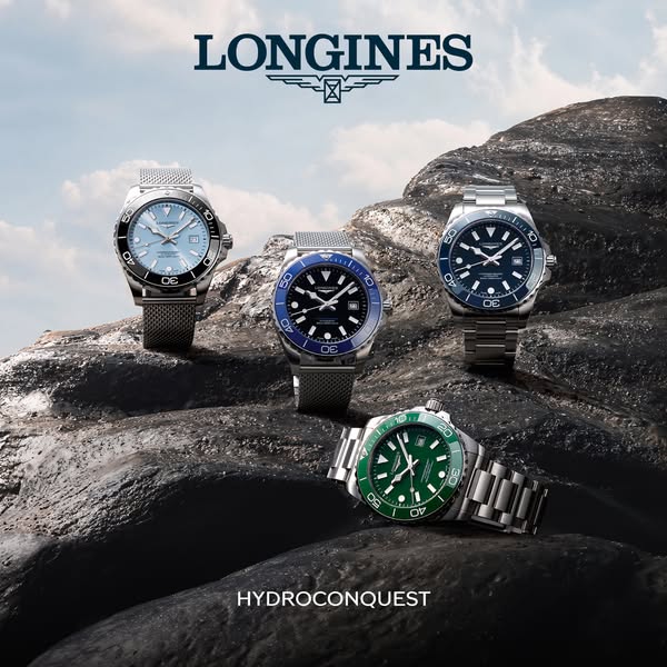 An advertisement for Longines Hydroconquest watches. Four different watch models are presented against a rock formation.