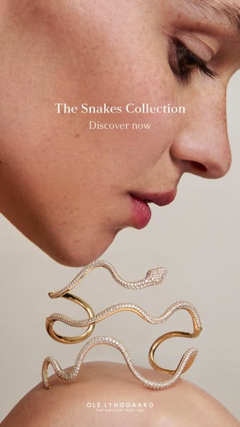 A minimalist ad that is focused on the snake collection jewelry product. The model is seen wearing the jewelry, which se