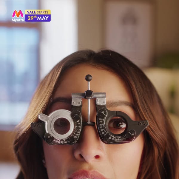 This image ad for Myntra features a woman wearing an eye exam tool, which is used to point out the upcoming start of the