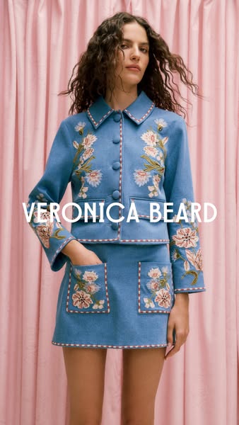 This image ad features a woman modeling a Veronica Beard jacket and skirt. The brand name is displayed over the image.