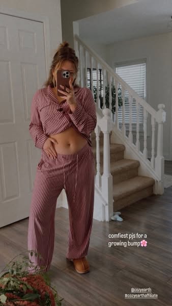 This ad features a woman taking a mirror selfie in a bedroom to showcase a pair of Cozy Earth pajamas that are comfortab