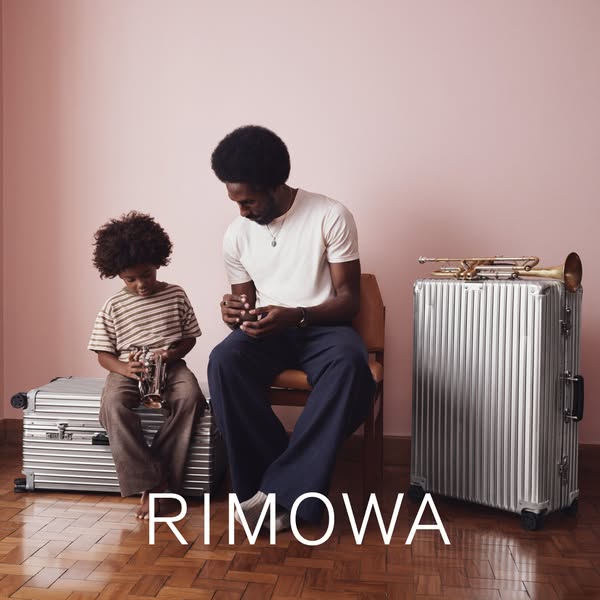 This ad shows a father and son, along with two Rimowa suitcases. The visual elements portray a theme of family and trave