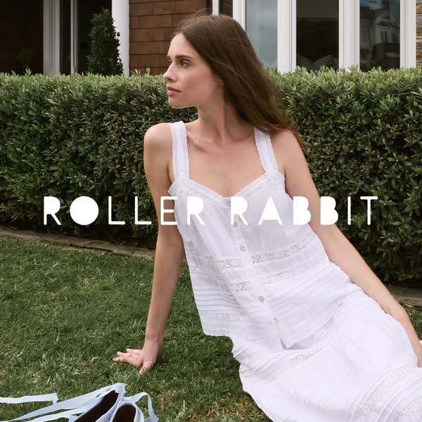 An ad promoting Roller Rabbit apparel, featuring a model in an all-white pajama set outdoors.