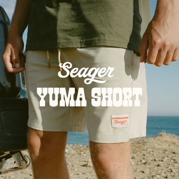 This ad features a man standing near a car on a sunny day. The man is wearing a pair of khaki shorts and an olive green 