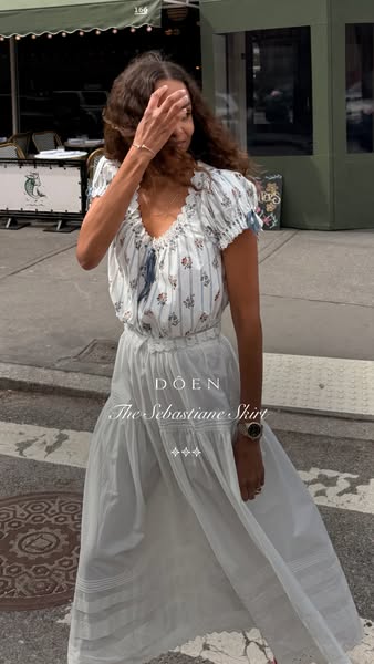 An advertisement for the Doen brand's "The Sebastiane Skirt." A woman wearing a Doen top and the skirt is 