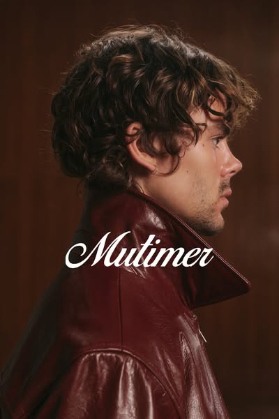 This ad features a close up shot of a person's side profile wearing a maroon leather jacket. The brand name 'Mul
