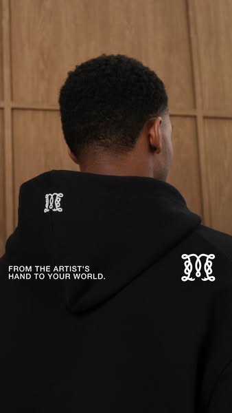 Ad showcases a black hoodie with the brand's logo and the text 'FROM THE ARTIST'S HAND TO YOUR WORLD.'