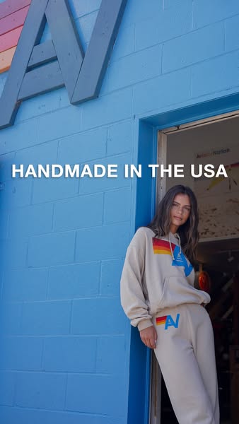 This ad showcases a matching hoodie and sweatpants set from Aviator Nation. The ad highlights that the clothing is handm