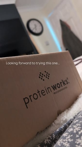 An image ad featuring a Protein Works package. The image is shot up close and in a personal vlogging style.