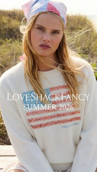 This LoveShackFancy ad features a woman outdoors modeling a sweater with a U.S. flag design. It highlights the brand and