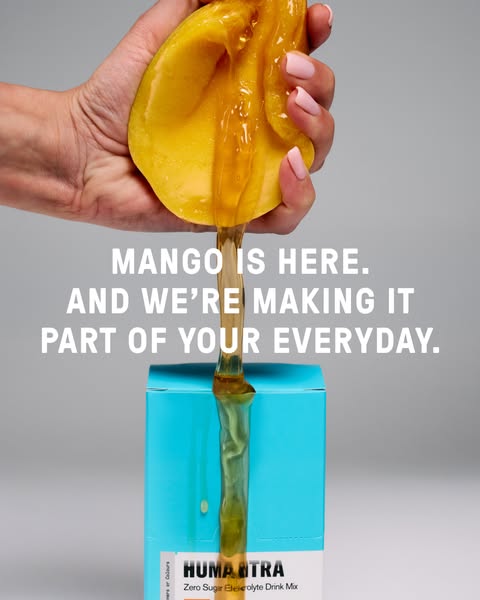 This ad shows mango liquid being squeezed onto a package of Humantra's zero sugar electrolyte drink mix.