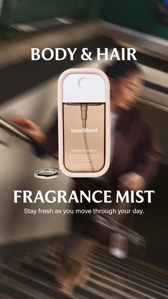 This ad features Touchland's Power Essence Fragrance Mist positioned in front of a blurred background of a person on