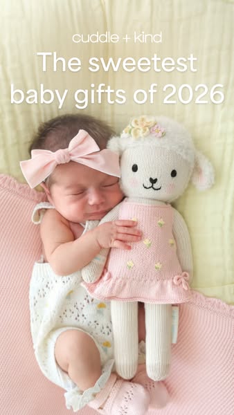 An image ad featuring a newborn baby sleeping with a plush lamb, promoting the brand's baby gifts.