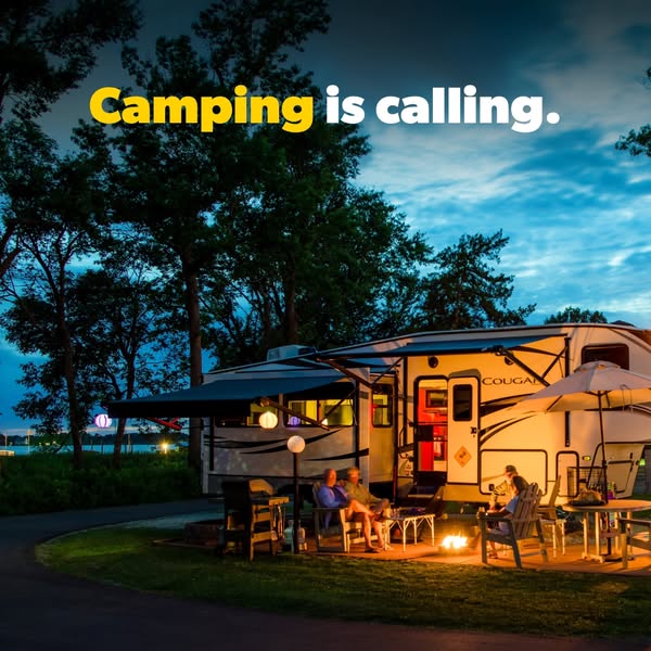 This image ad features a Cougar RV with people enjoying a campfire outside of it. The ad is meant to evoke the feeling o