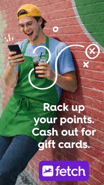 The Fetch ad depicts a man in a green apron happily looking at his phone and holding an iced coffee against a brick wall