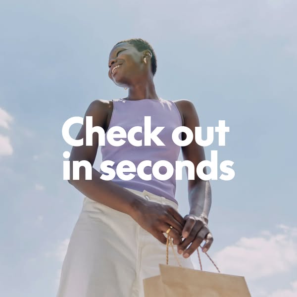 This ad features a smiling Black woman with a low-angle shot of her walking outside holding shopping bags. White text ov