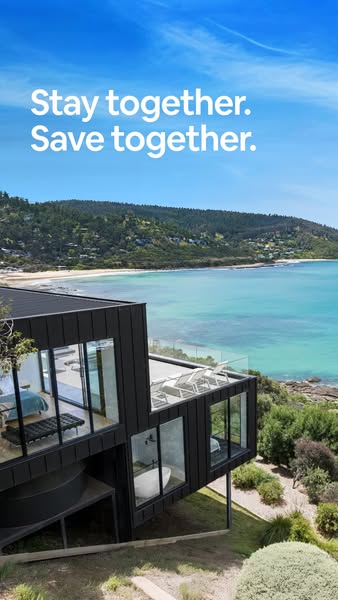 This image ad showcases a modern house overlooking a coastal landscape. The ad emphasizes the idea of staying and saving