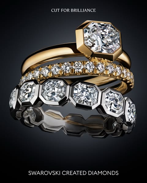 This ad features a stack of three Swarovski created diamond rings against a dark background, highlighting the brilliance