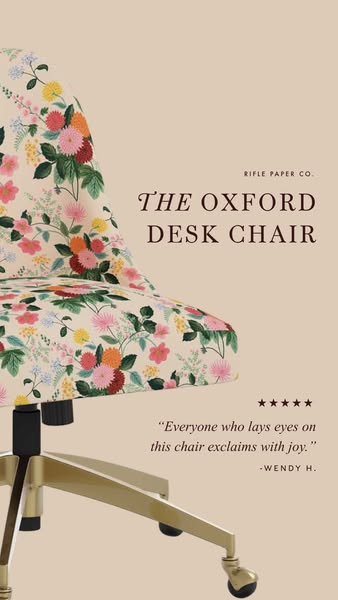 This image ad showcases the Rifle Paper Co. Oxford Desk Chair, emphasizing its aesthetic appeal and comfort through a cu