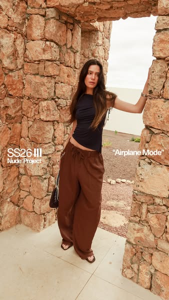 This ad showcases a woman in a casual, yet stylish outfit, promoting the fashion brand Nude Project and their SS26 III c