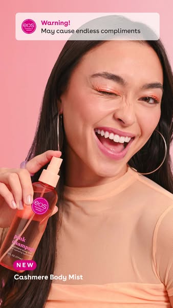 This ad for EOS body mist features a winking woman holding the bottle, framed by a notification that using the product m