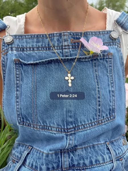 This ad features an image of a person wearing a necklace with a cross pendant. The focus is on the cross necklace and is