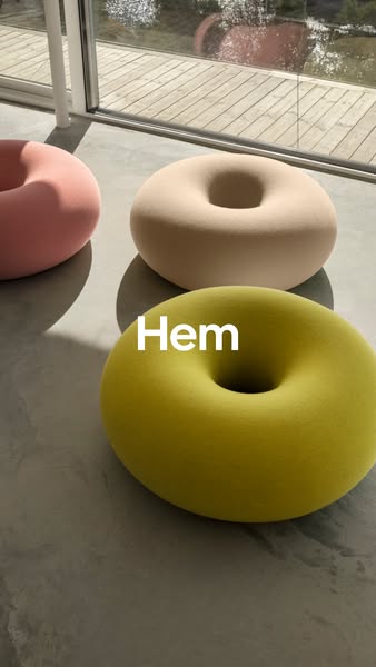 This ad showcases three donut-shaped poufs from Hem in different colors. The ad is a simple product showcase with a focu
