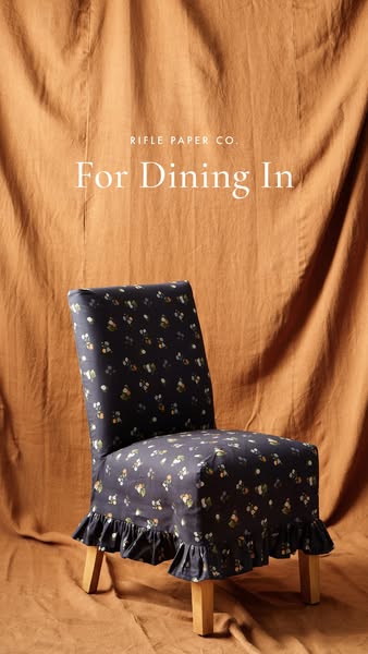 This ad showcases a Rifle Paper Co. chair cover, emphasizing its design and suitability for dining in.