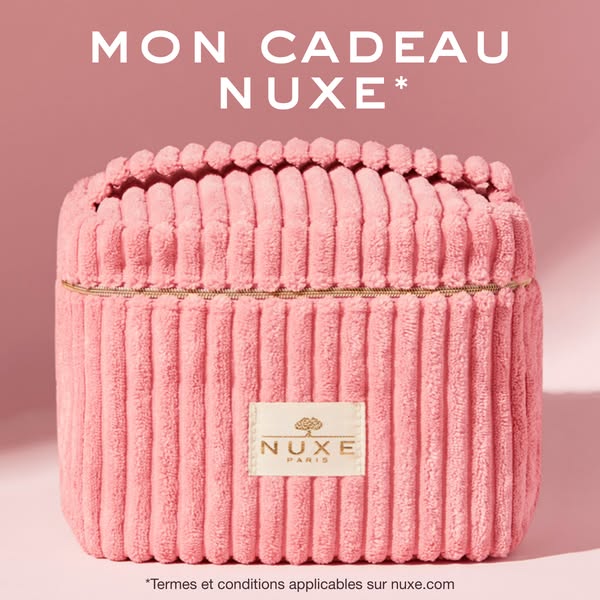 This ad features a pink Nuxe travel case against a matching pink background. The text emphasizes that the bag is "m