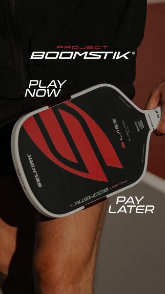 This ad features a close-up shot of a person holding a Selkirk Project Boomstik paddle. The ad uses minimal text, highli