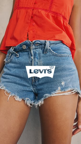 This Levi's ad features a close-up shot of a woman wearing distressed denim shorts and a coral top. The brand's 