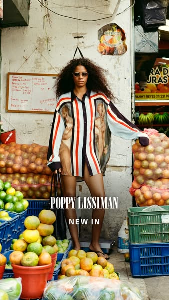 This image ad showcases a woman wearing a shirt dress from Poppy Lissiman's new collection. The model is standing in