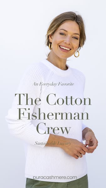 This image ad for Pura Cashmere features a woman wearing The Cotton Fisherman Crew sweater. The ad highlights the produc