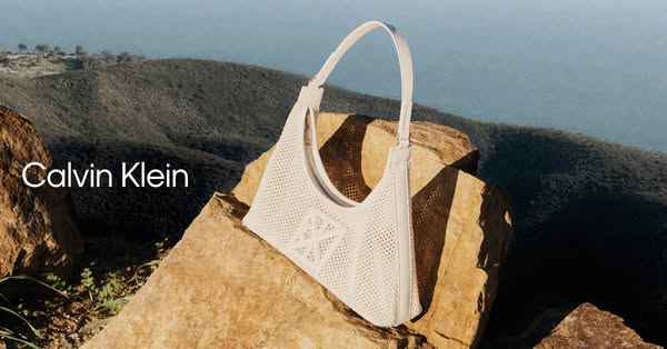 This image ad showcases a Calvin Klein purse that is staged on a mountaintop.