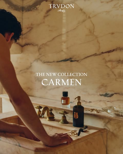 An advertisement showcasing the new Carmen collection by Trudon. The image is a close-up of a marble countertop and sink