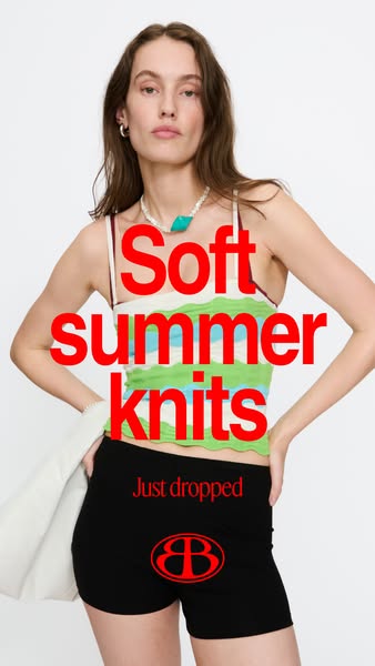 The ad features a woman wearing a striped knit crop top and shorts while standing in front of a plain white background. 