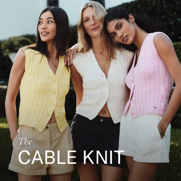 This ad showcases three women wearing Tommy Hilfiger cable knit sweater vests. The women are standing close together, ca