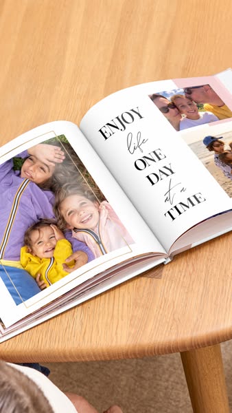 This image ad features an open photo album with a caption encouraging viewers to enjoy life one day at a time. The photo