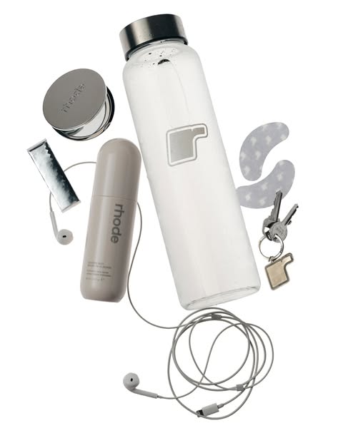 This ad features a flatlay of Rhode products and other lifestyle items, suggesting that Rhode products are essential for