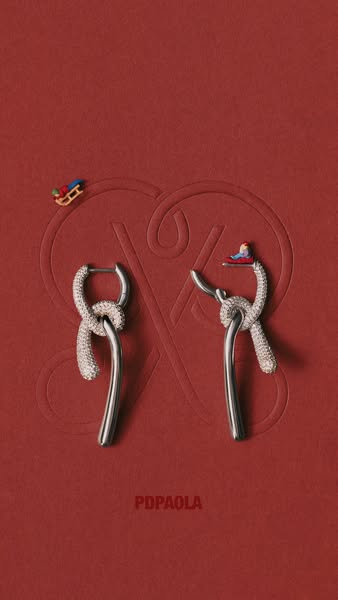 This ad features a pair of PDPaola earrings on a red background with a debossed logo. Two miniature figurines on sleds a