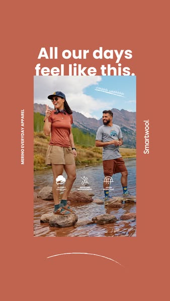 An ad for Smartwool brand apparel showing a man and woman standing in a mountain stream, wearing Smartwool socks, shorts