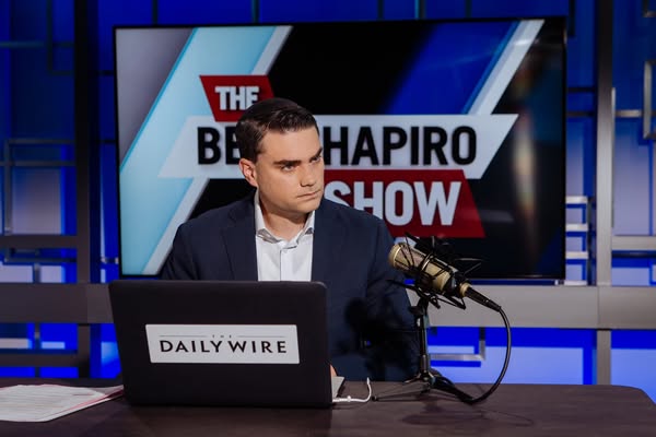 This ad features an image of Ben Shapiro in his studio during a recording of his show. The ad promotes The Daily Wire.