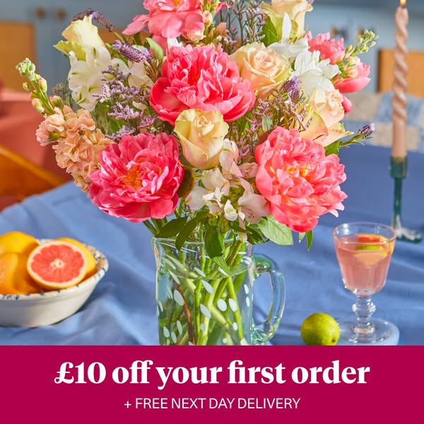 The ad is for a flower delivery service and it features a picture of a fresh bouquet of pink, peach, and white flowers i