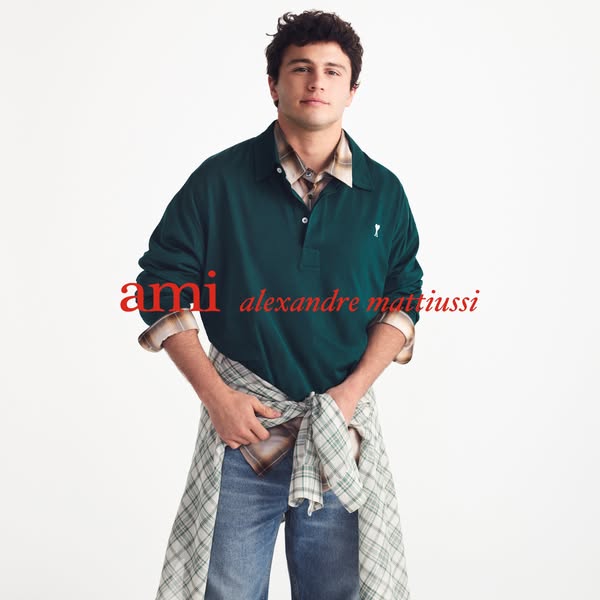 This ad for AMI Paris features a male model wearing multiple items from the brand's clothing line. The brand name an