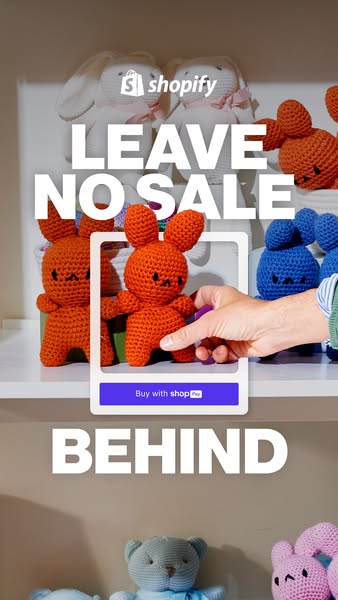 The ad features a collection of stuffed animals displayed on shelves. A hand is shown holding a phone with a square fram