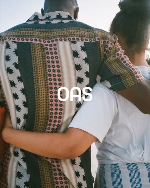 This ad features a close-up shot of two people embracing, highlighting the clothing brand OAS with its logo prominently 
